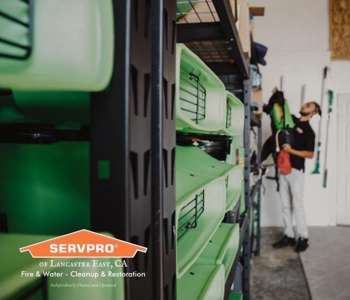 Shelves stacked with green SERVPRO equipment